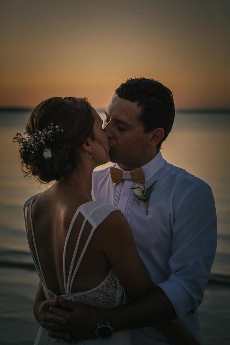 Couple walking along Honeymoon Island beach at sunset