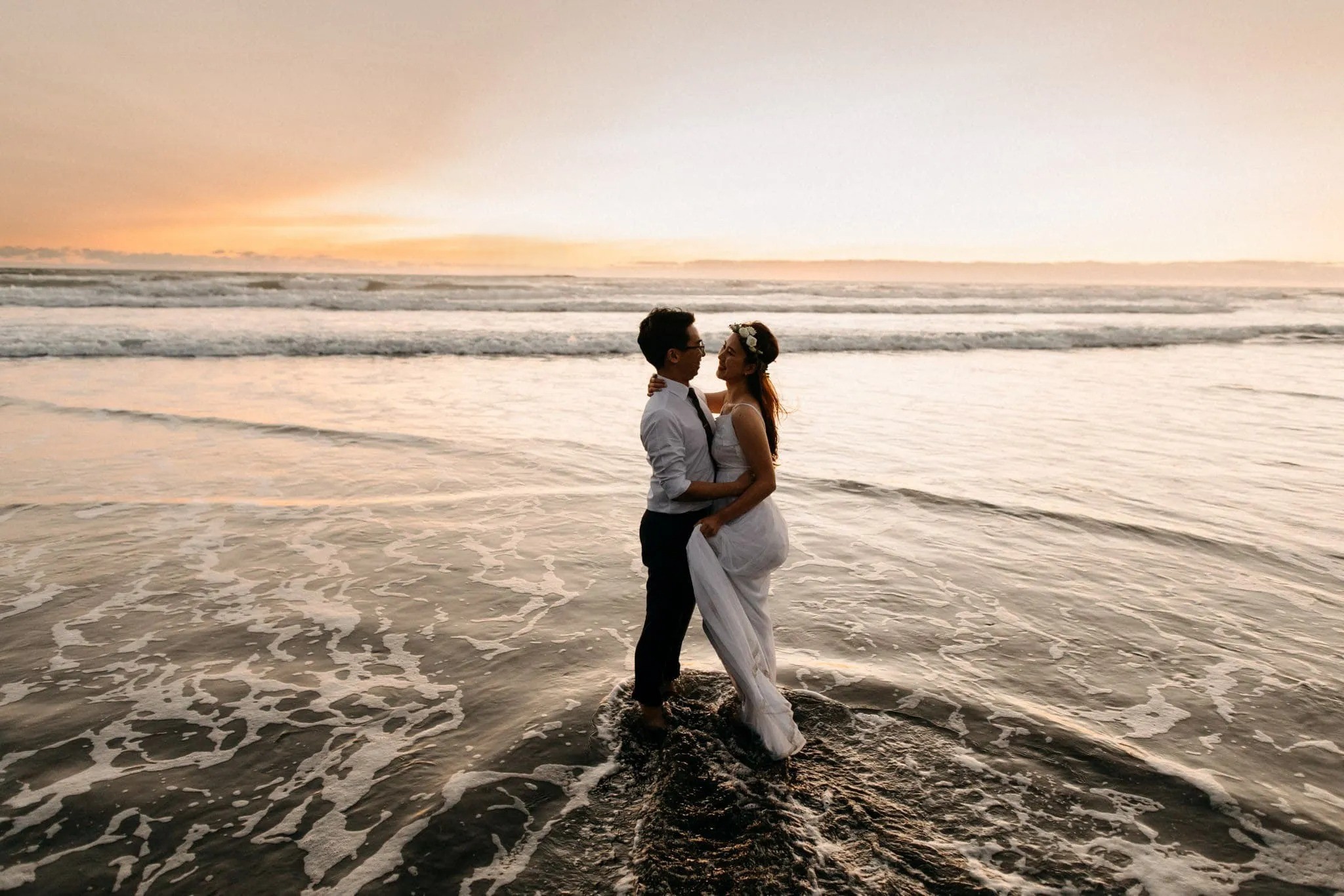 Junpei and Ovelia kiss during a romantic Gulf Coast sunset wedding at Clearwater Beach