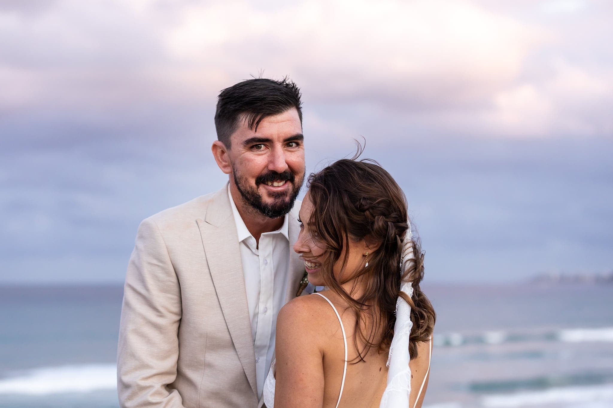 Newlyweds walking the shoreline after Indian Rocks Beach Airbnb wedding