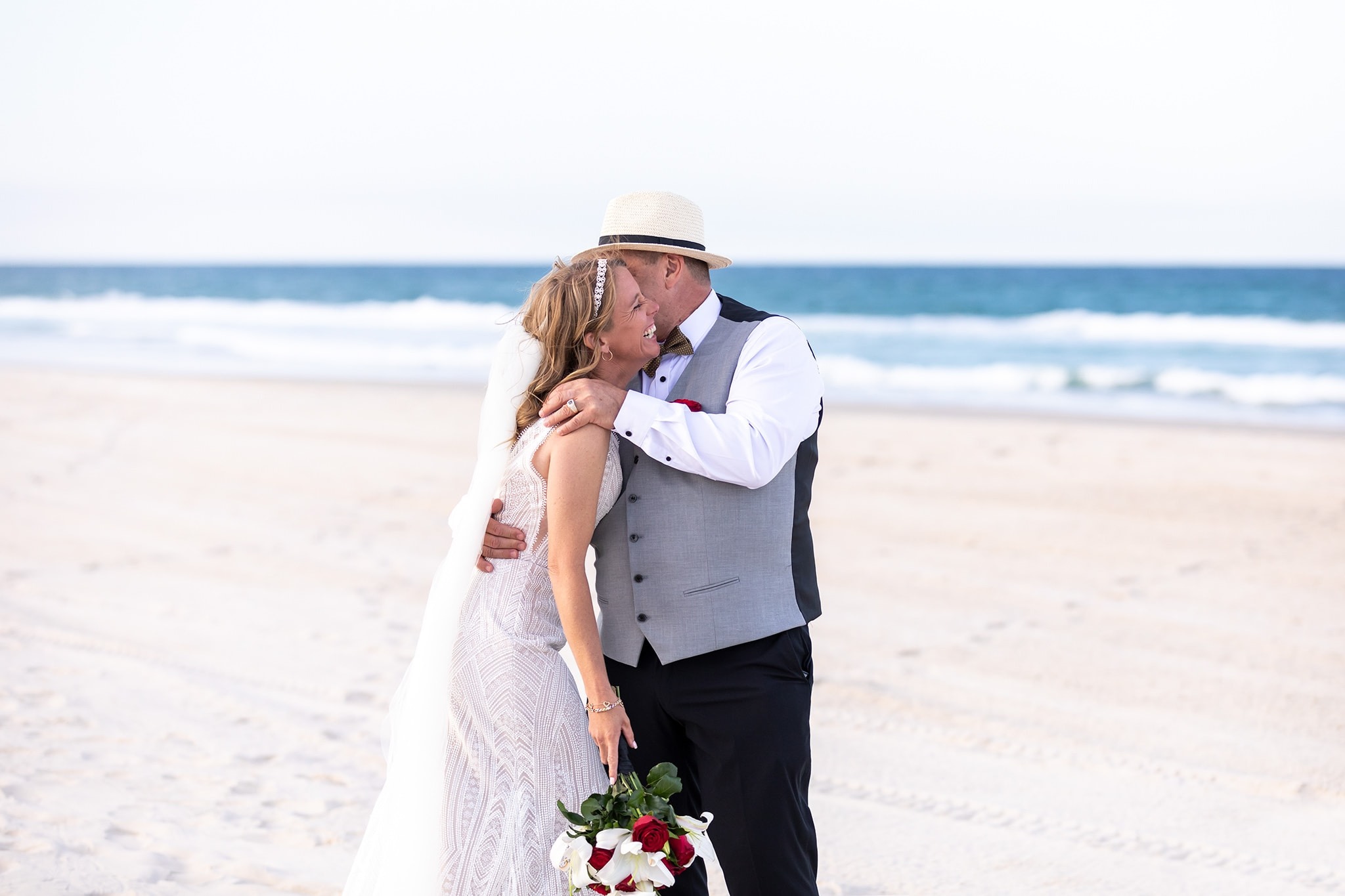 Vows By The Sea wedding arch setup with Gulf Coast backdrop