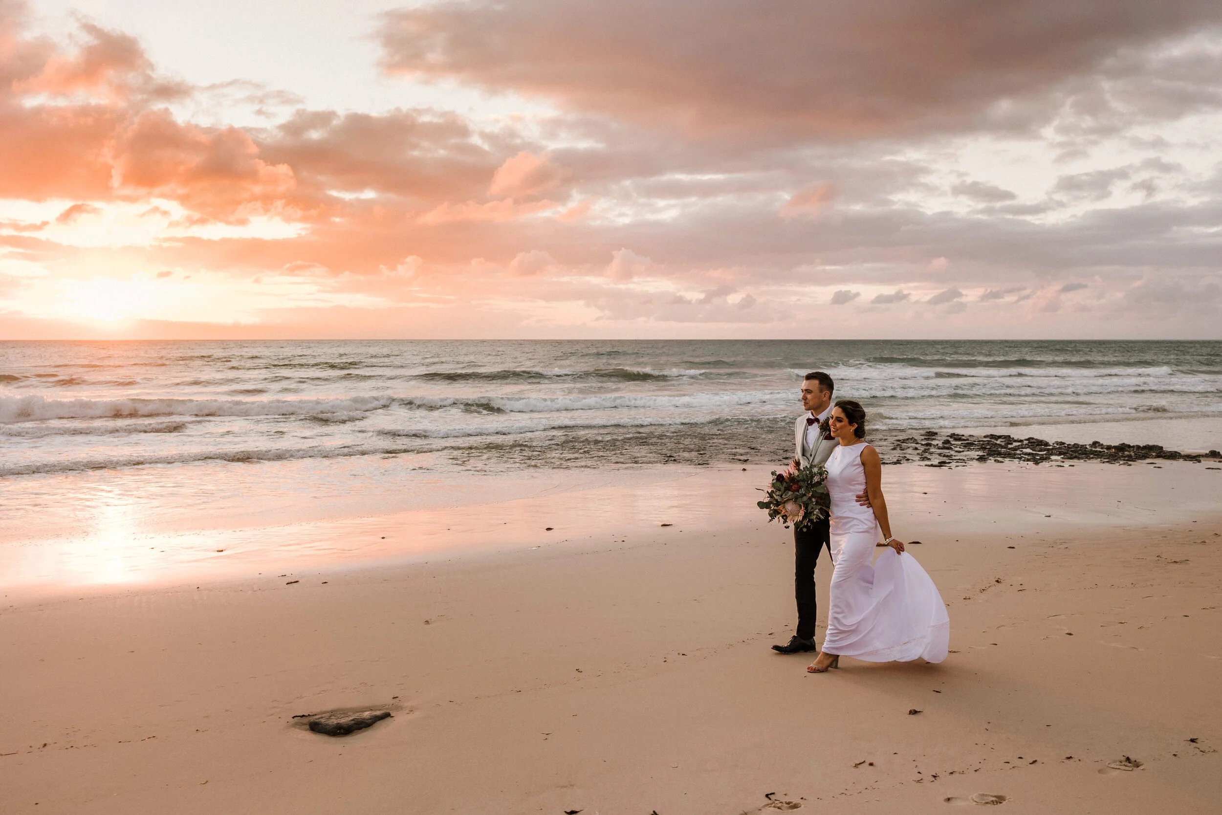 Couple holding hands at Clearwater Beach elopement ceremony