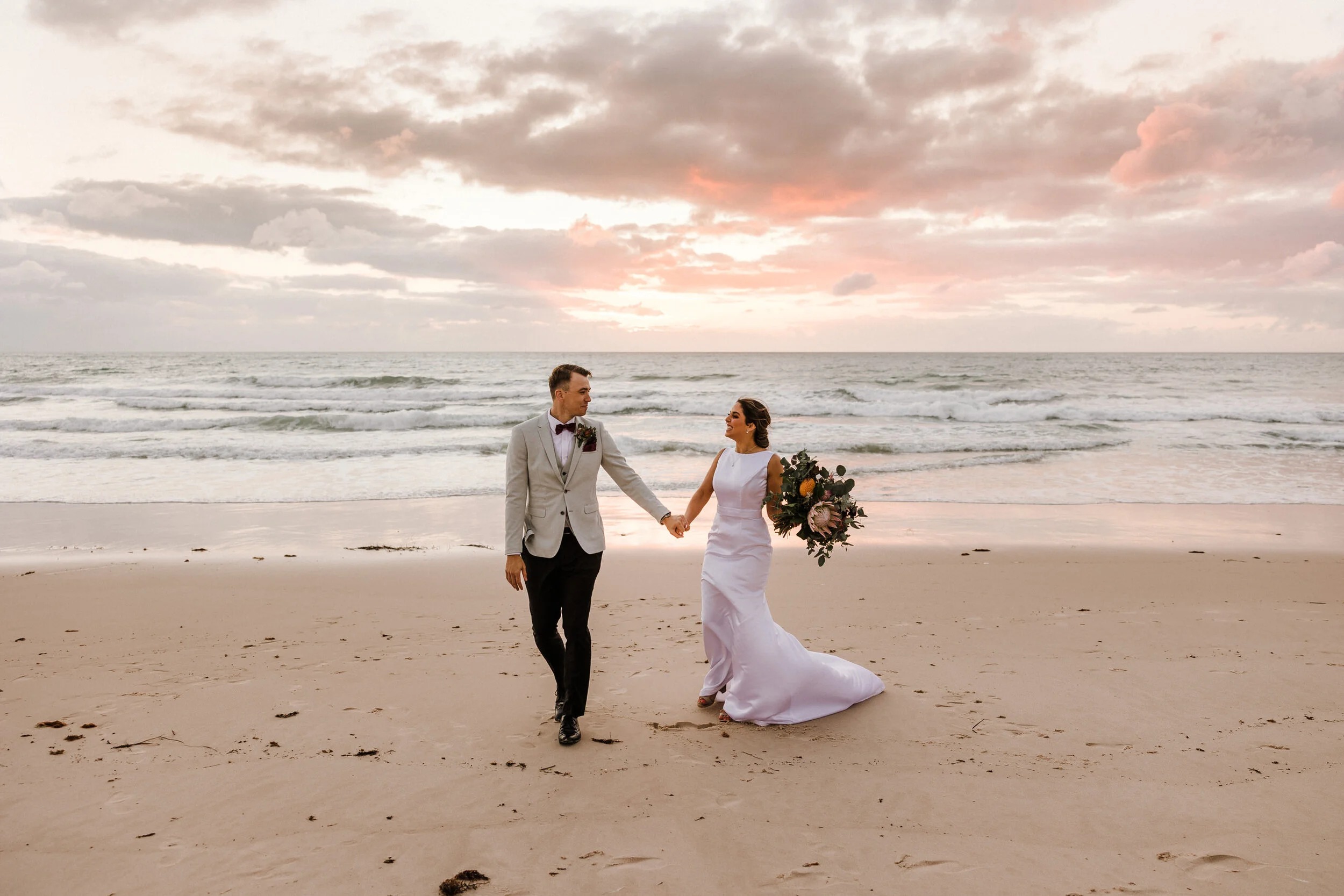 Bride walking barefoot on Clearwater Beach at elopement