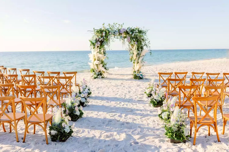 Sand Key Park beach wedding aisle leading to a floral arch by the Gulf